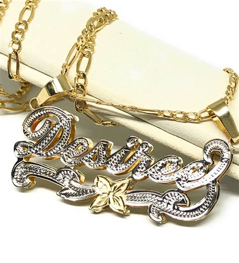 Mens name chain - An essential piece for every modern man. Our Cuban Link Chains are available in 10K and 14K yellow, white, and rose gold, and come in a variety of styles. We also offer different sizes of length and width, so that your Cuban Link Chain looks exactly how you want it. Our best-selling Men’s Monaco Chain Miami Cuban Link Chain Necklace is a bold ... 